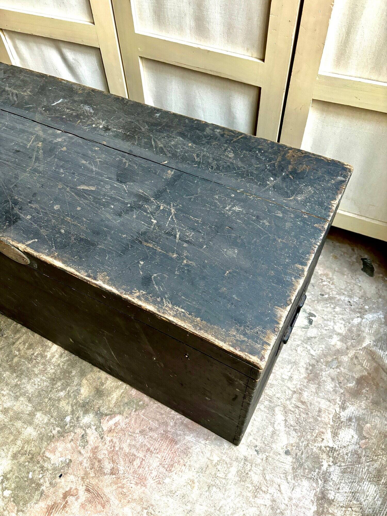 Trunk, black wooden chest and wallpaper