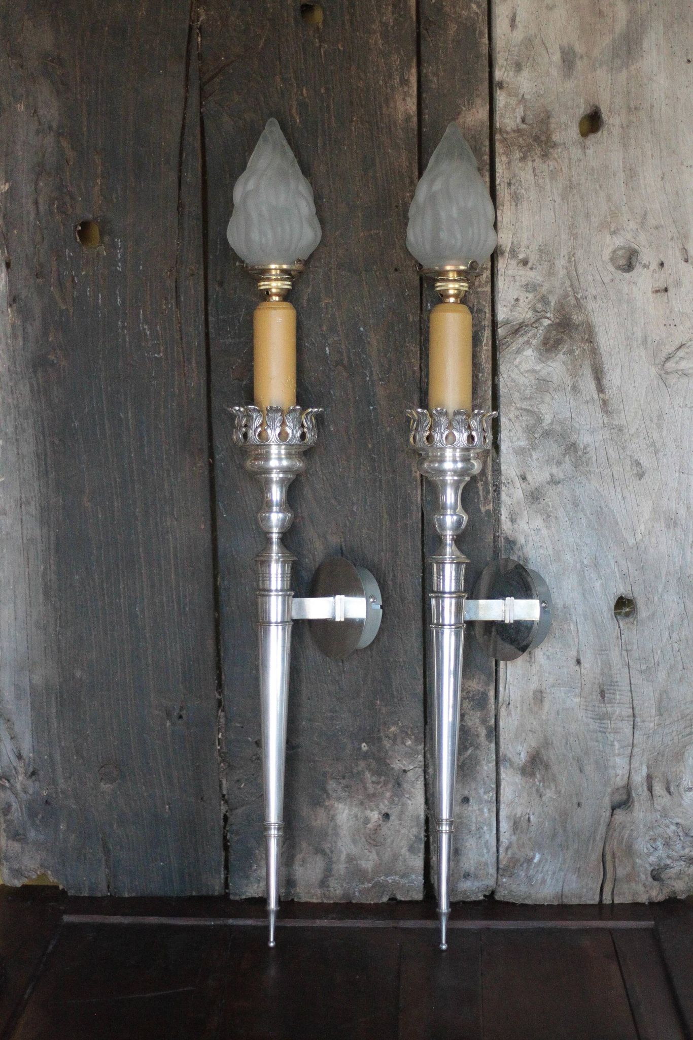 Large pair of silver-plated wall lights with flame globes, torches.