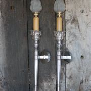 Large pair of silver-plated wall lights with flame globes, torches.