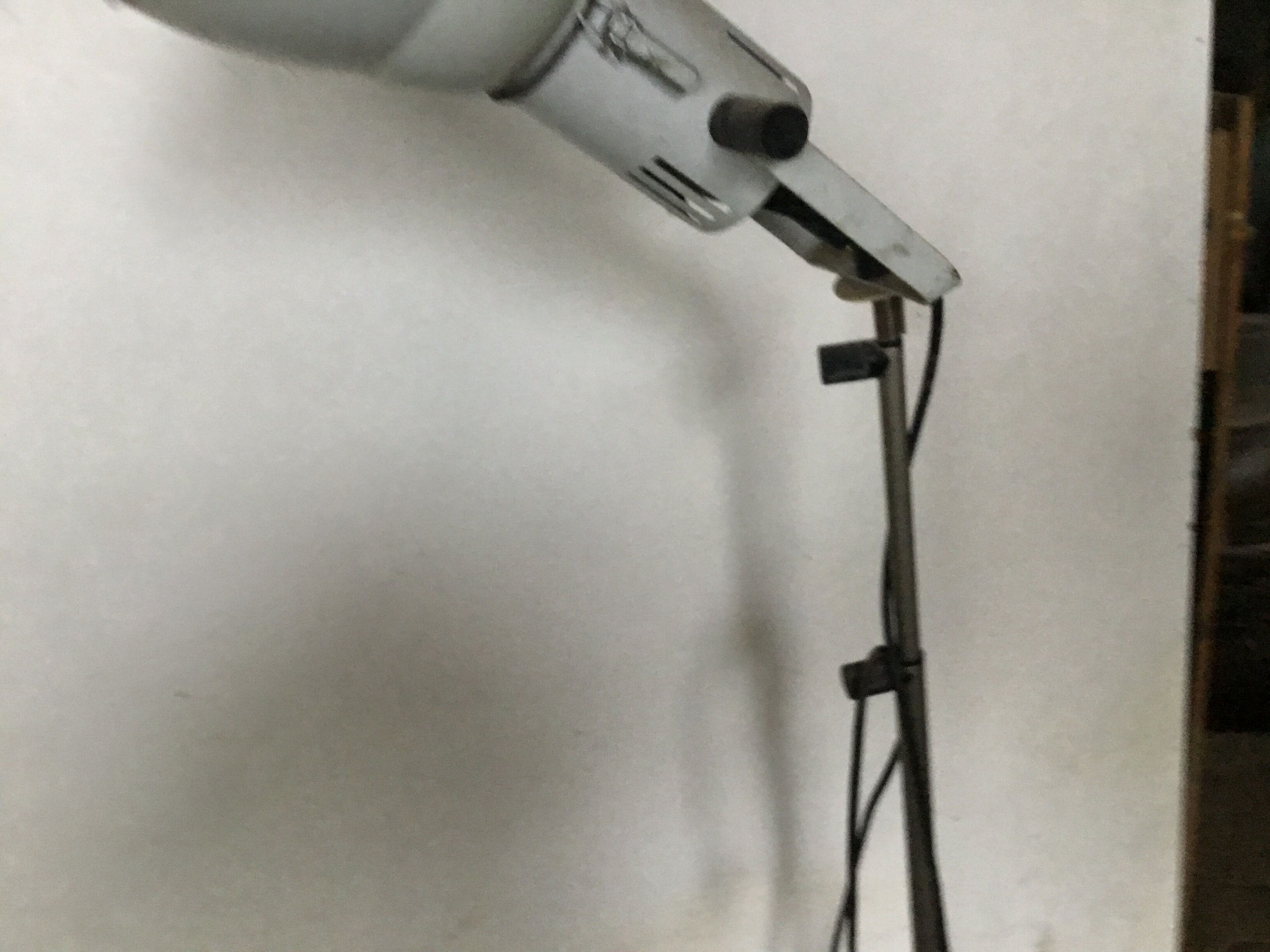 Industrial lamp on wrought iron tripod feet