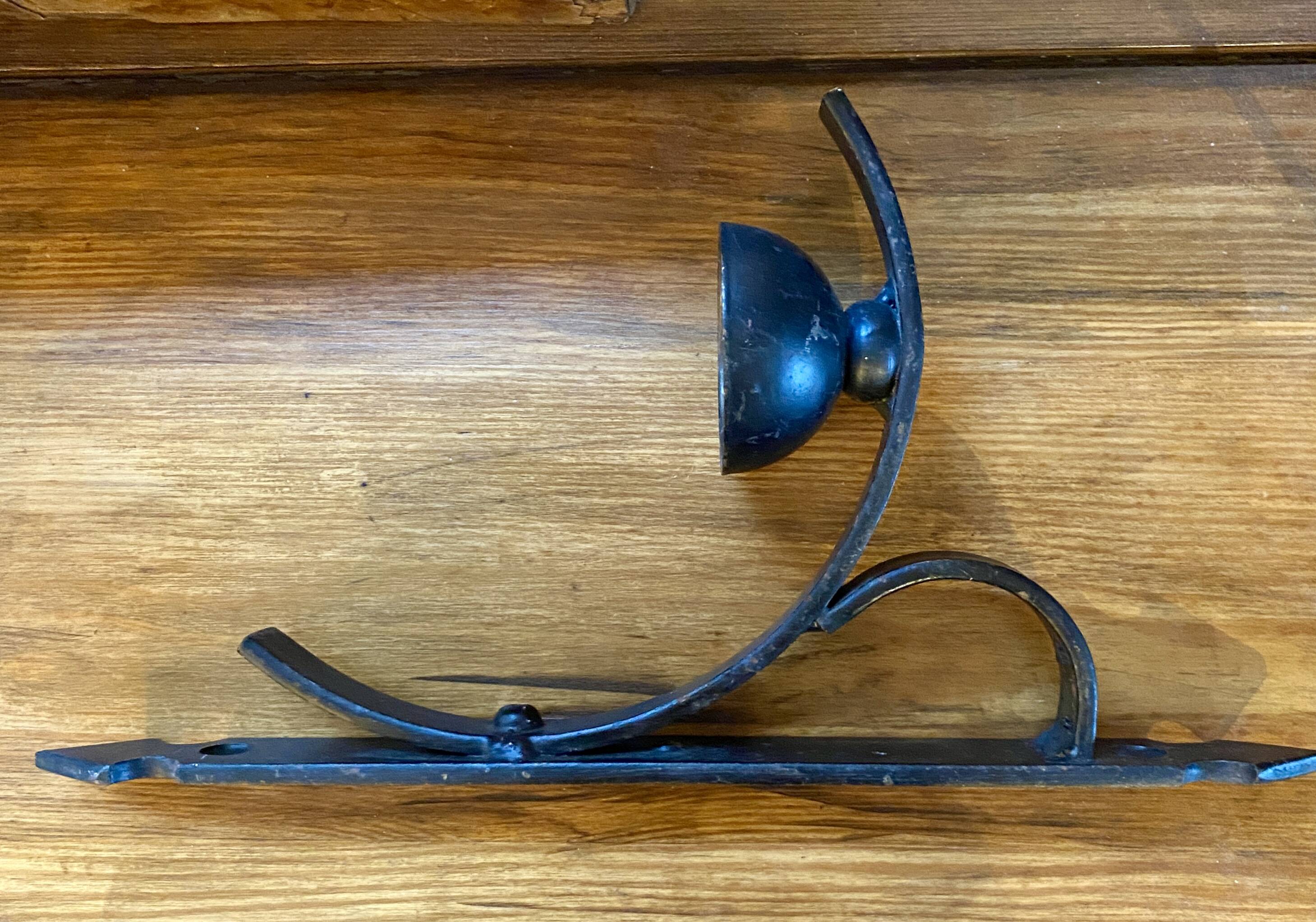 Two wrought iron wall lights, fabric cable.