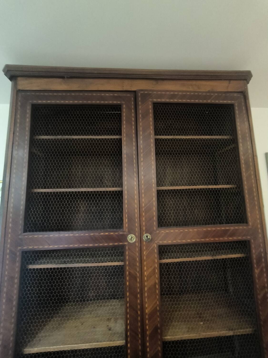 Library in marquetry with a grille from the Louis XVI period.