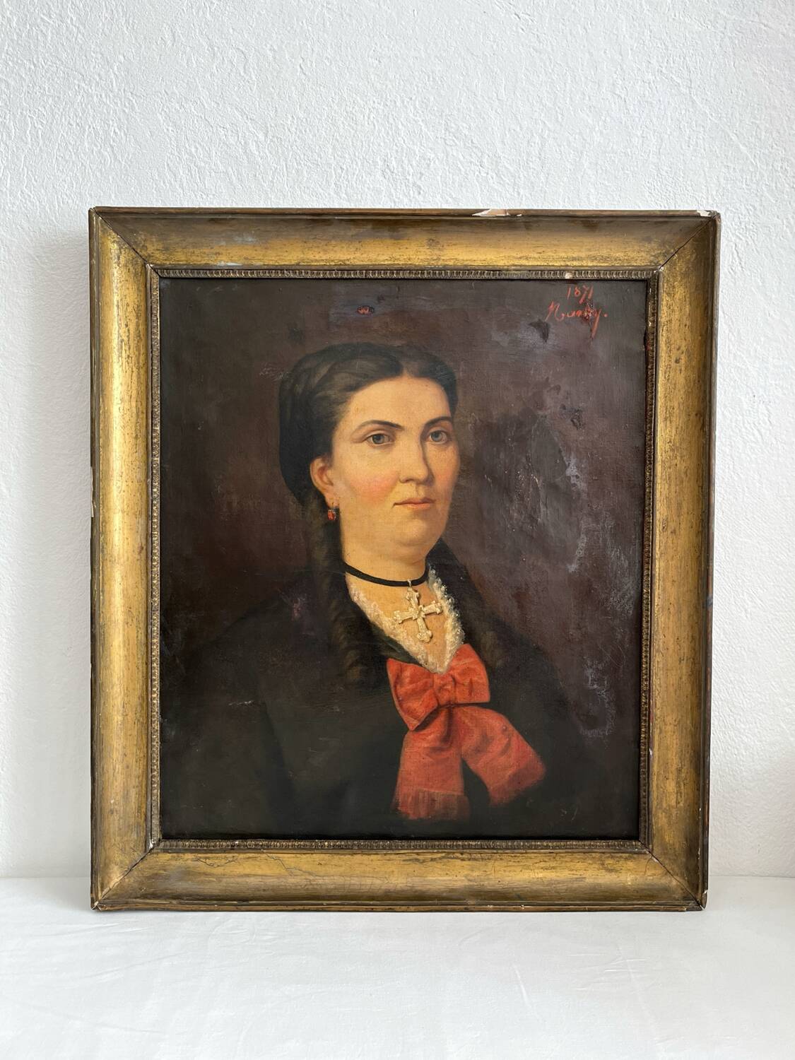 Old oil painting on canvas portrait of a woman with a red bow, late 19th century
