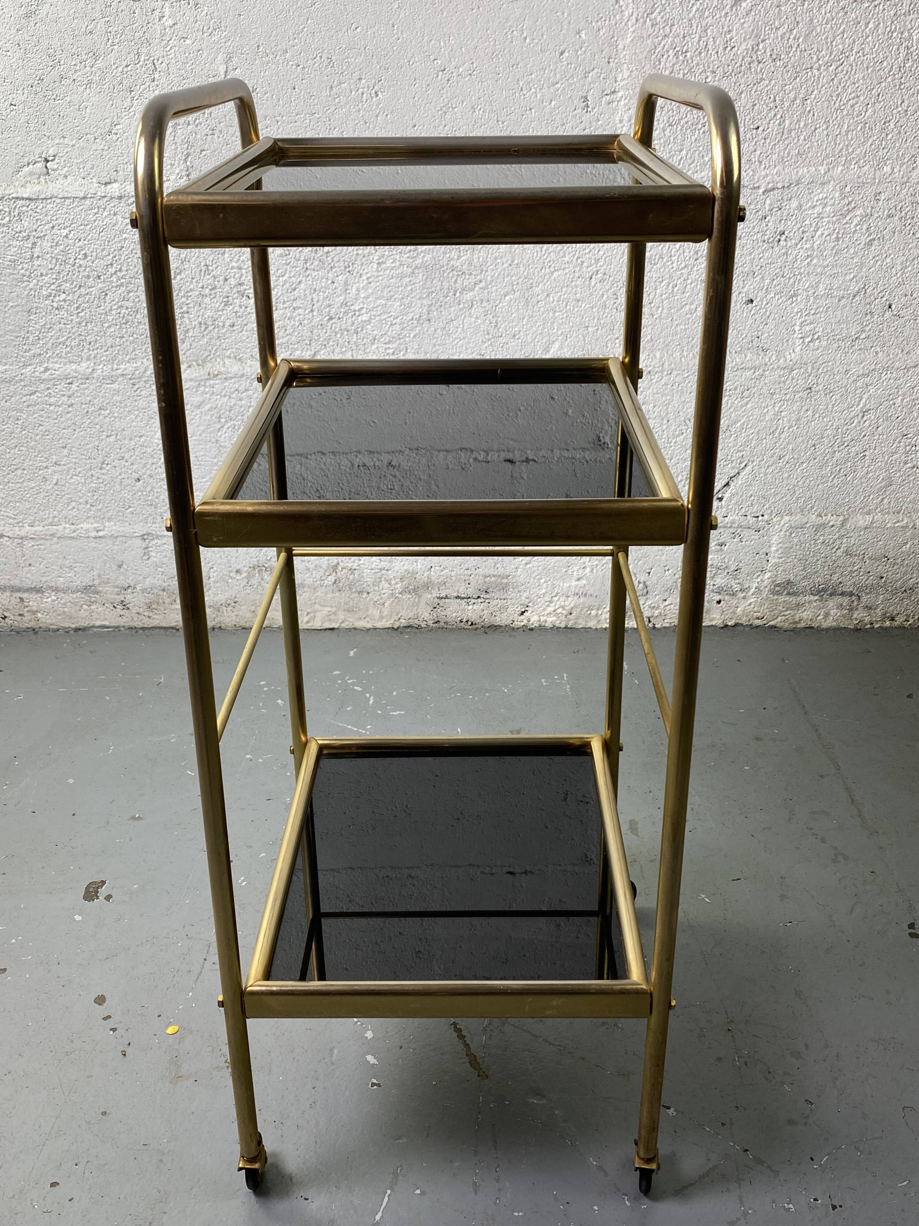 Small rolling trolley in brass and black plastic