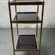 Small rolling trolley in brass and black plastic