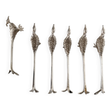 Six silver-plated knife rests in the shape of peacocks.