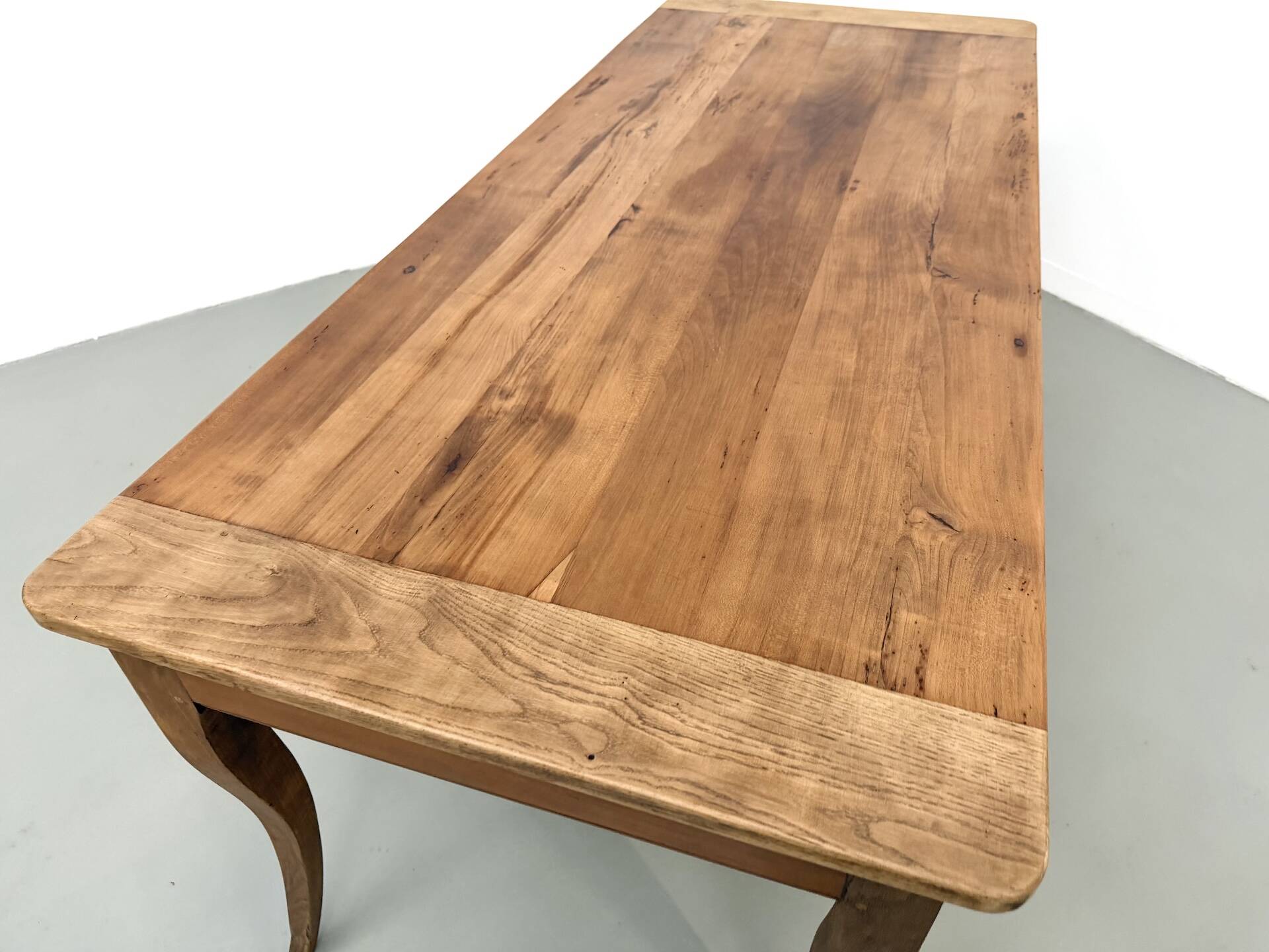 Farm table in solid cherry — Saber legs, Circa 1880