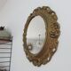 Golden baroque oval mirror, 60s-70s