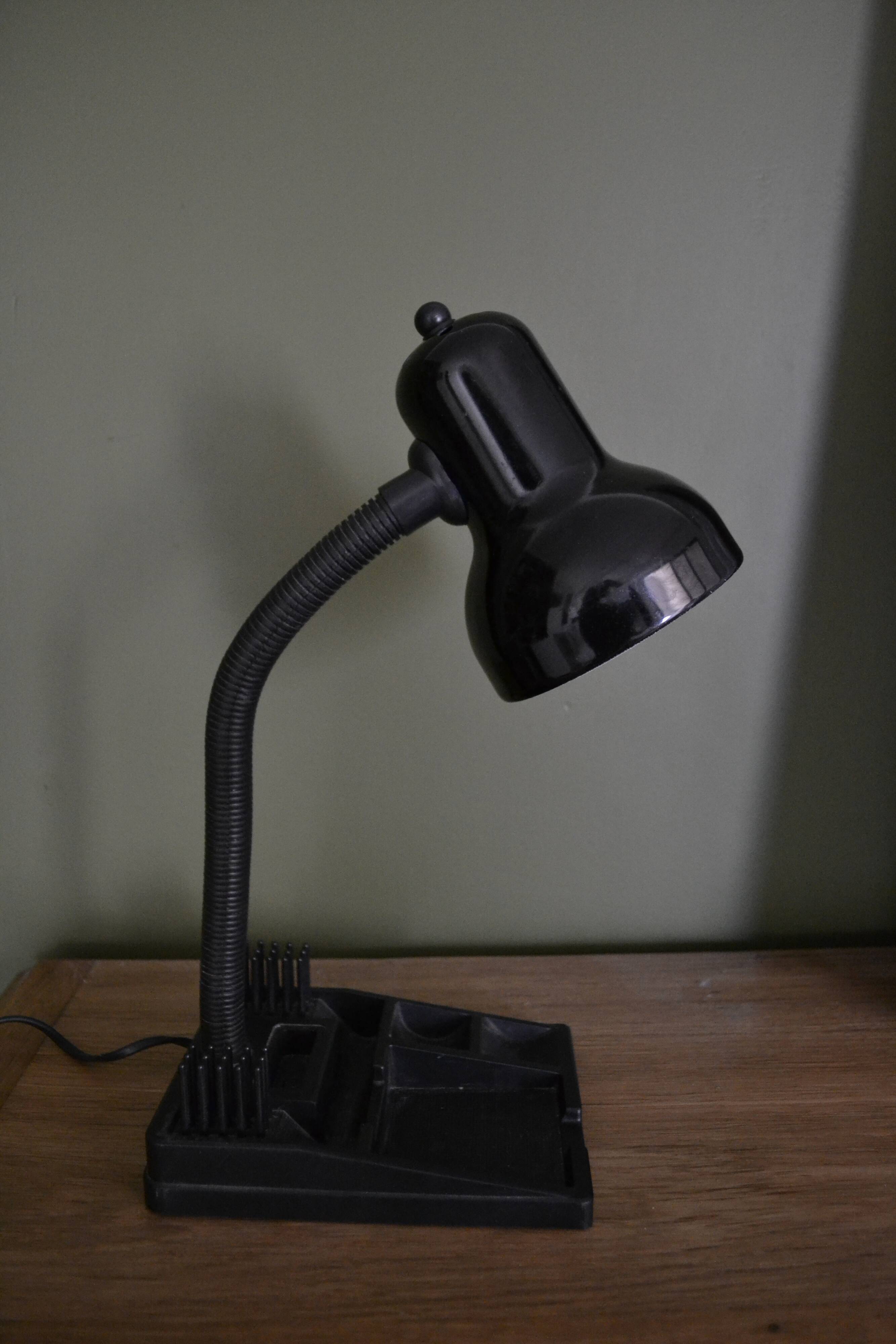 Black flexible desk lamp with built-in flashheld