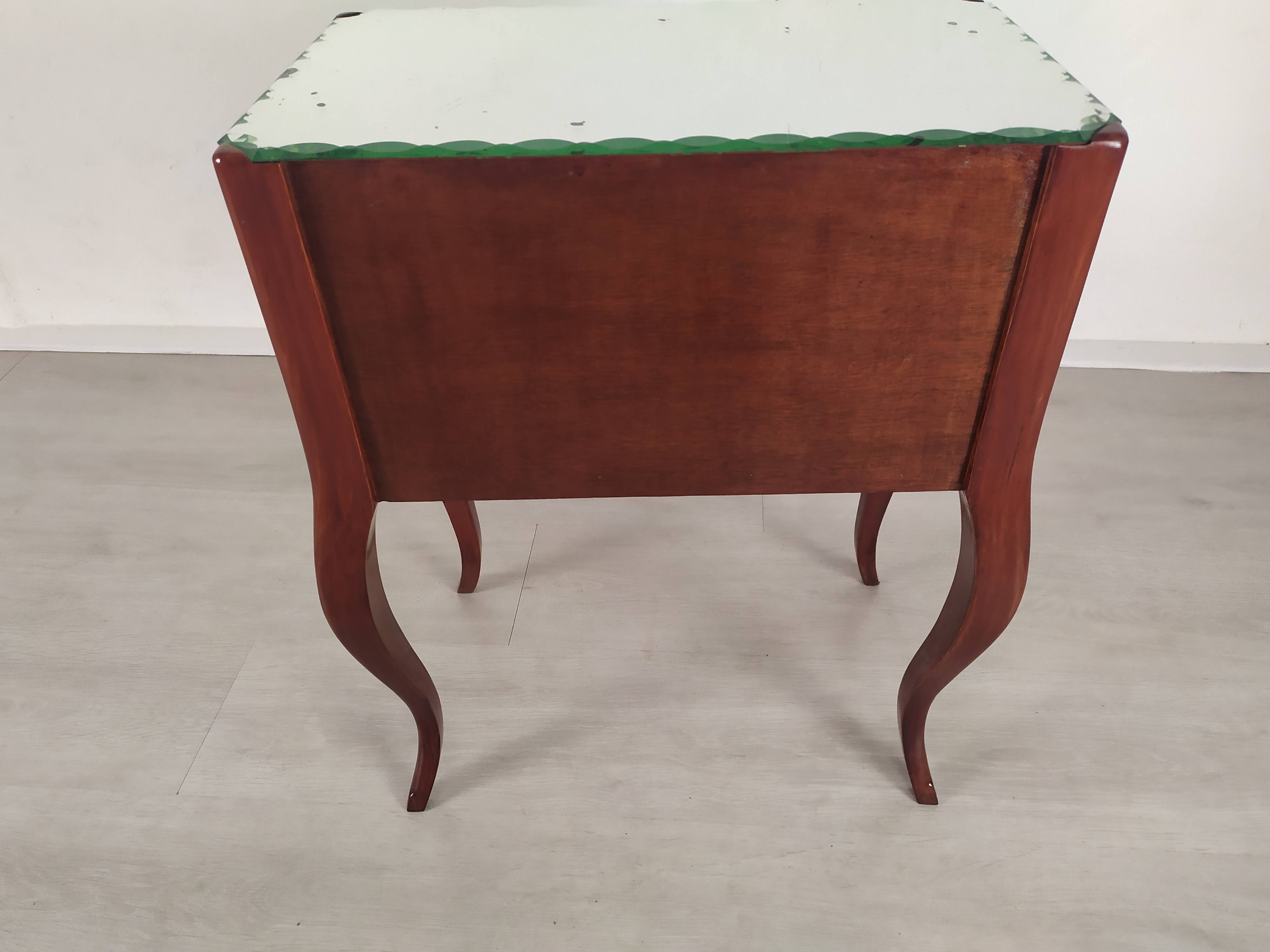 Glass art deco mirror beside table