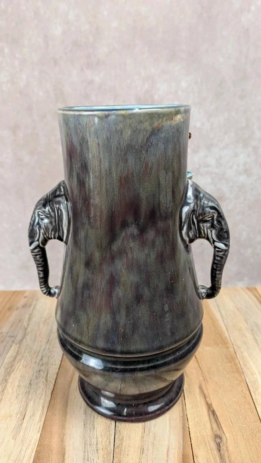 Antique vase in slipware with elephant and flower decoration.