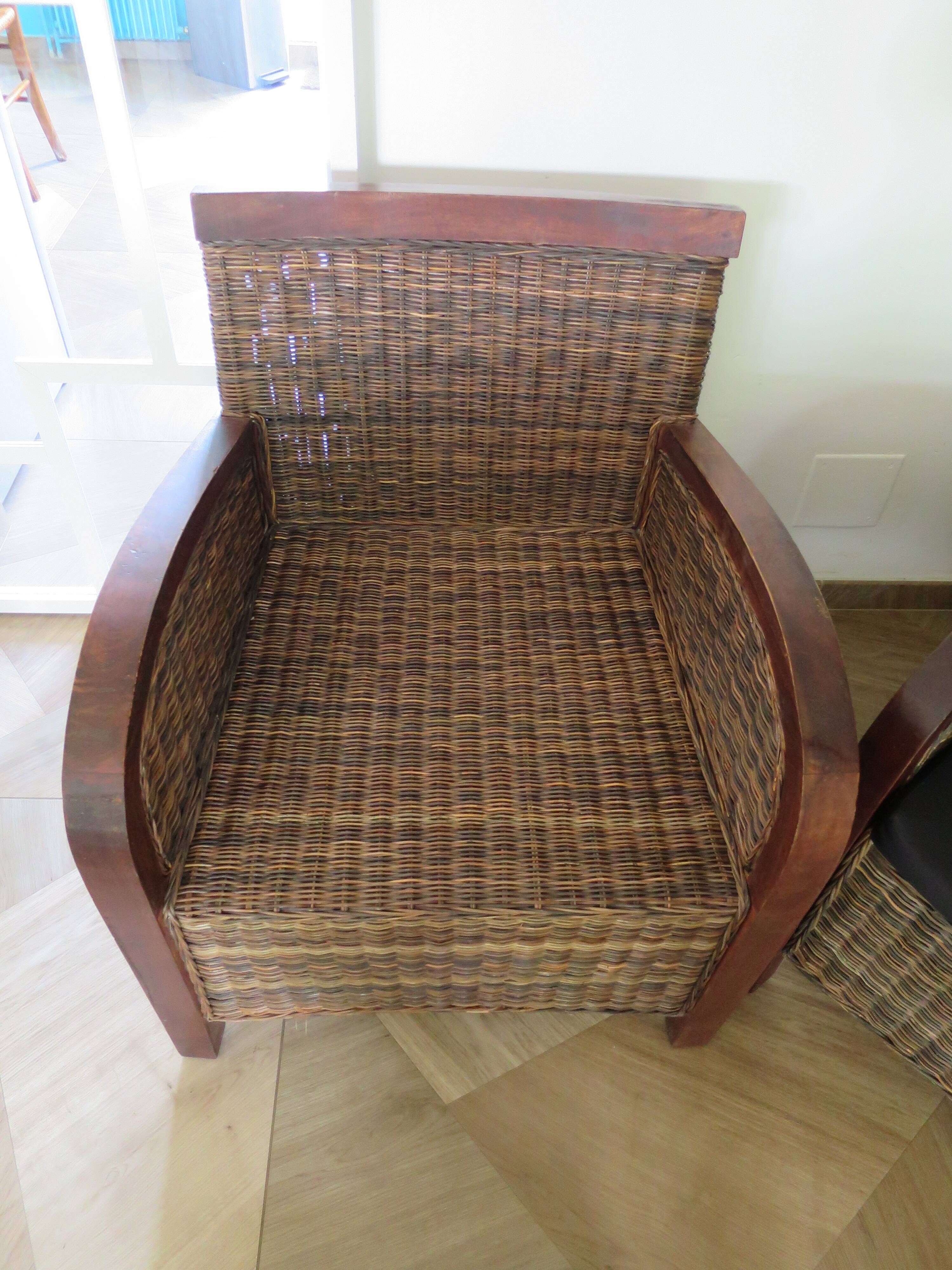2 colonial-style armchairs in woven rattan and exotic wood