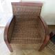 2 colonial-style armchairs in woven rattan and exotic wood