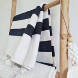 Hand-woven plaid with black stripes and white pompoms