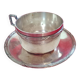 Silver-plated cup and saucer.