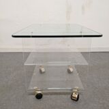 End of sofa with glass and plexiglass wheels from the 70s