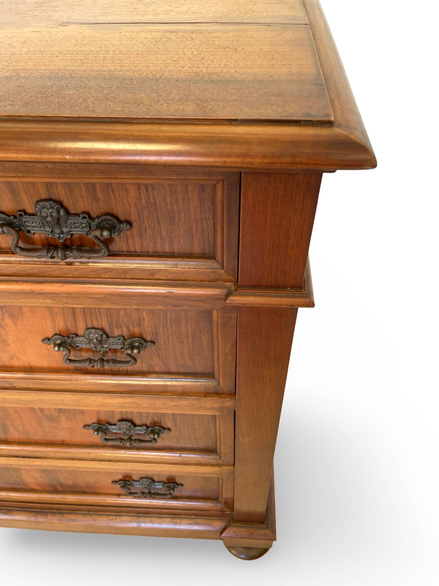 Antique walnut commode with bronze handles in the shape of a lion's mask,