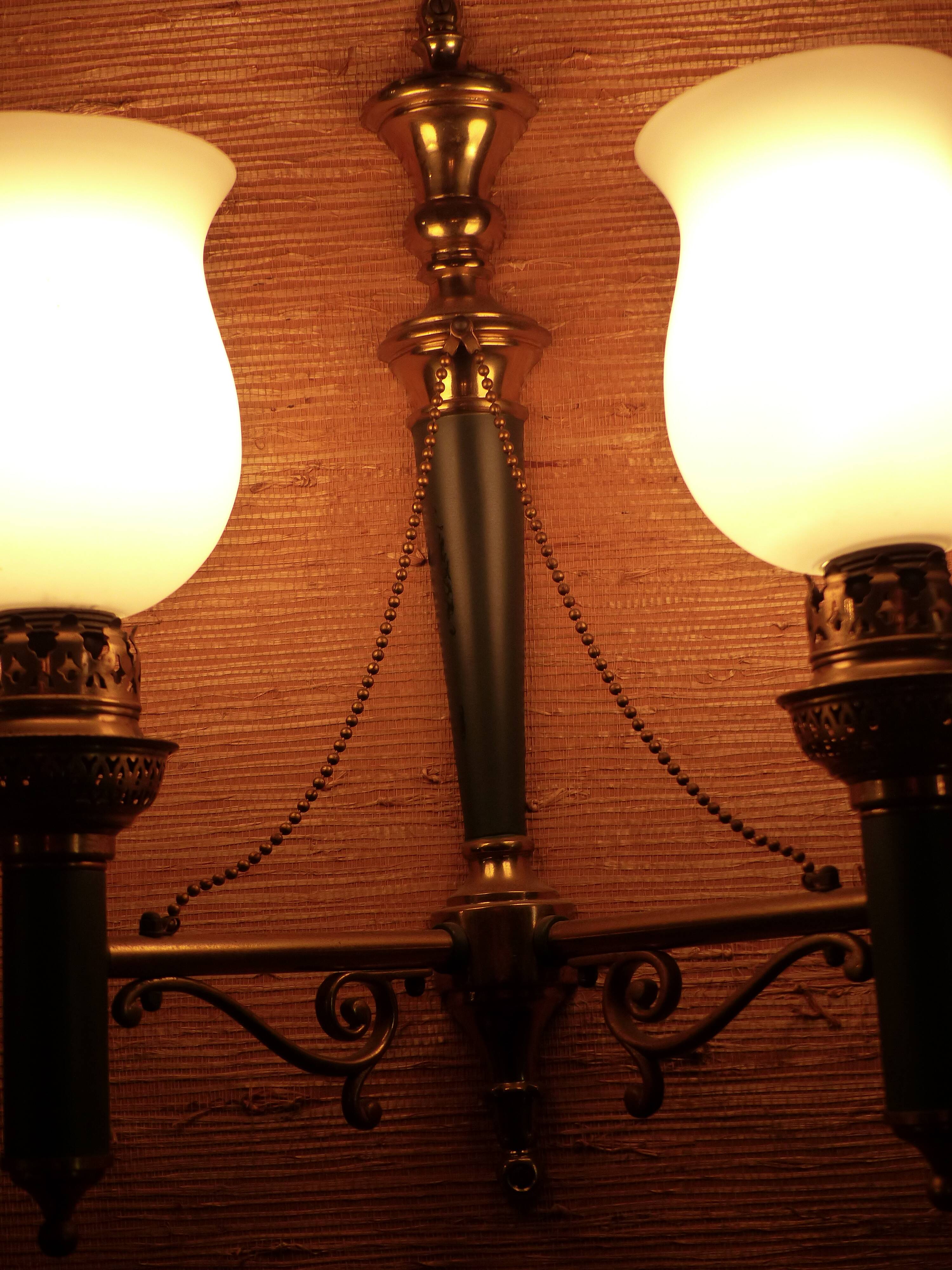 Brass wall sconce and frosted globe