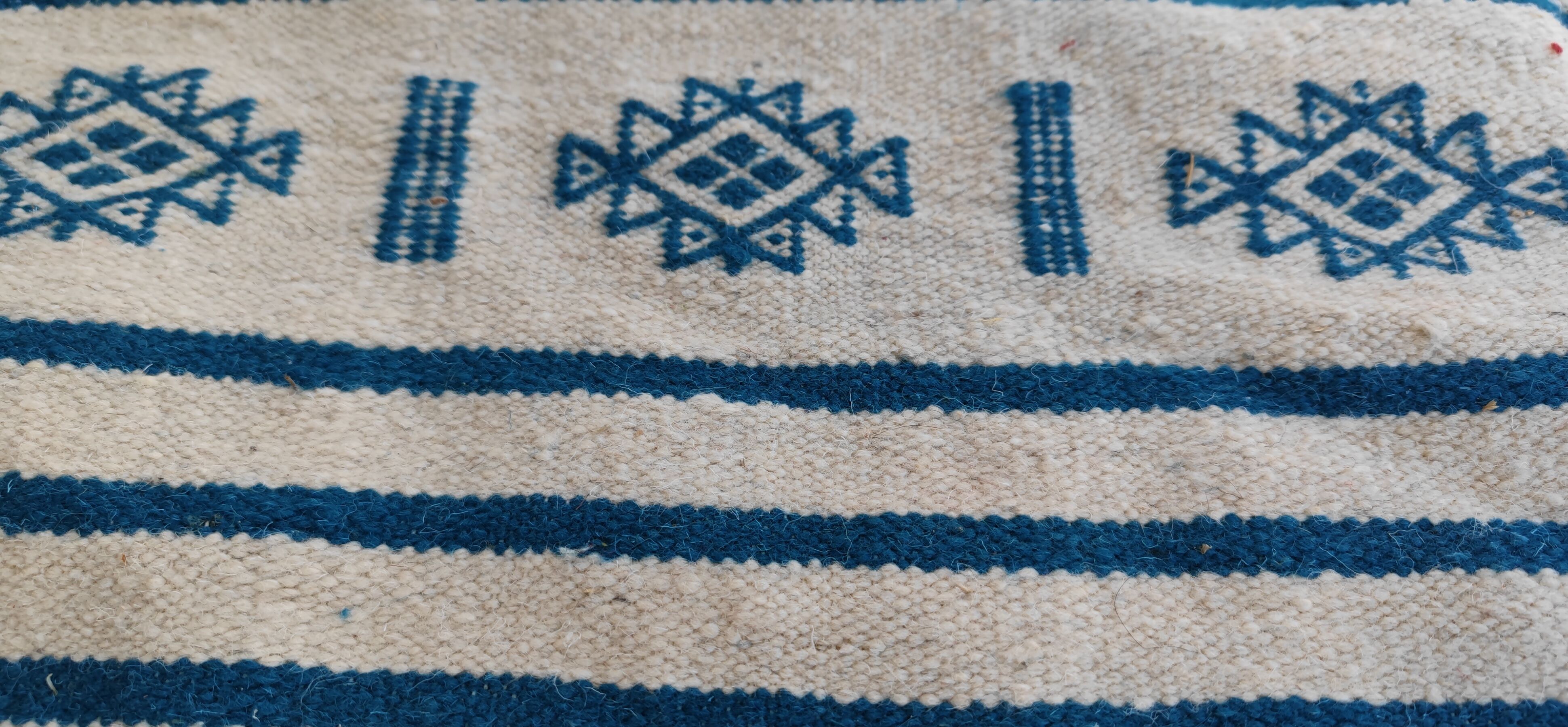 Traditional handmade white and blue kilim rug in natural wool