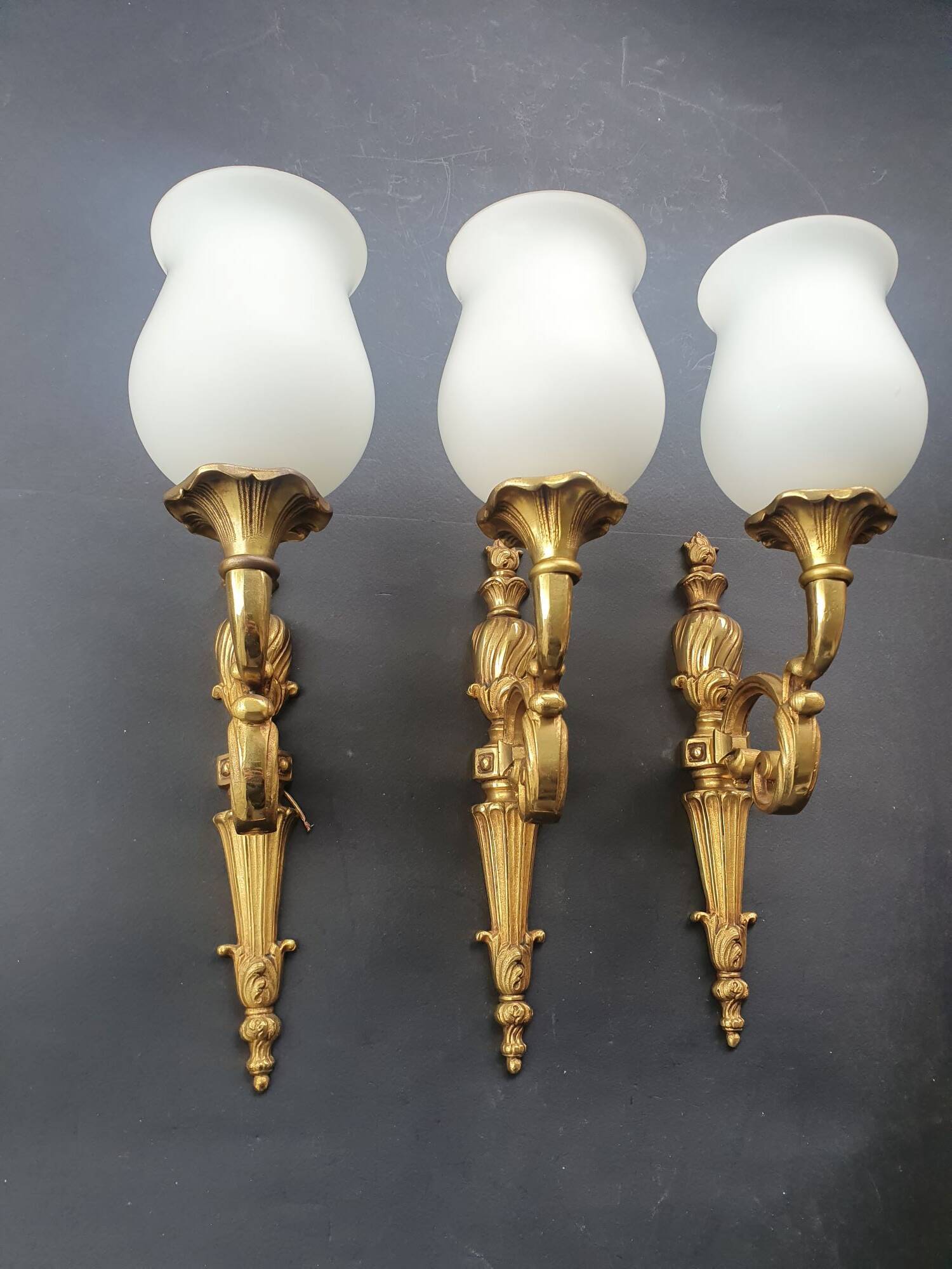 Three large vintage torch wall sconces.