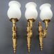 Three large vintage torch wall sconces.