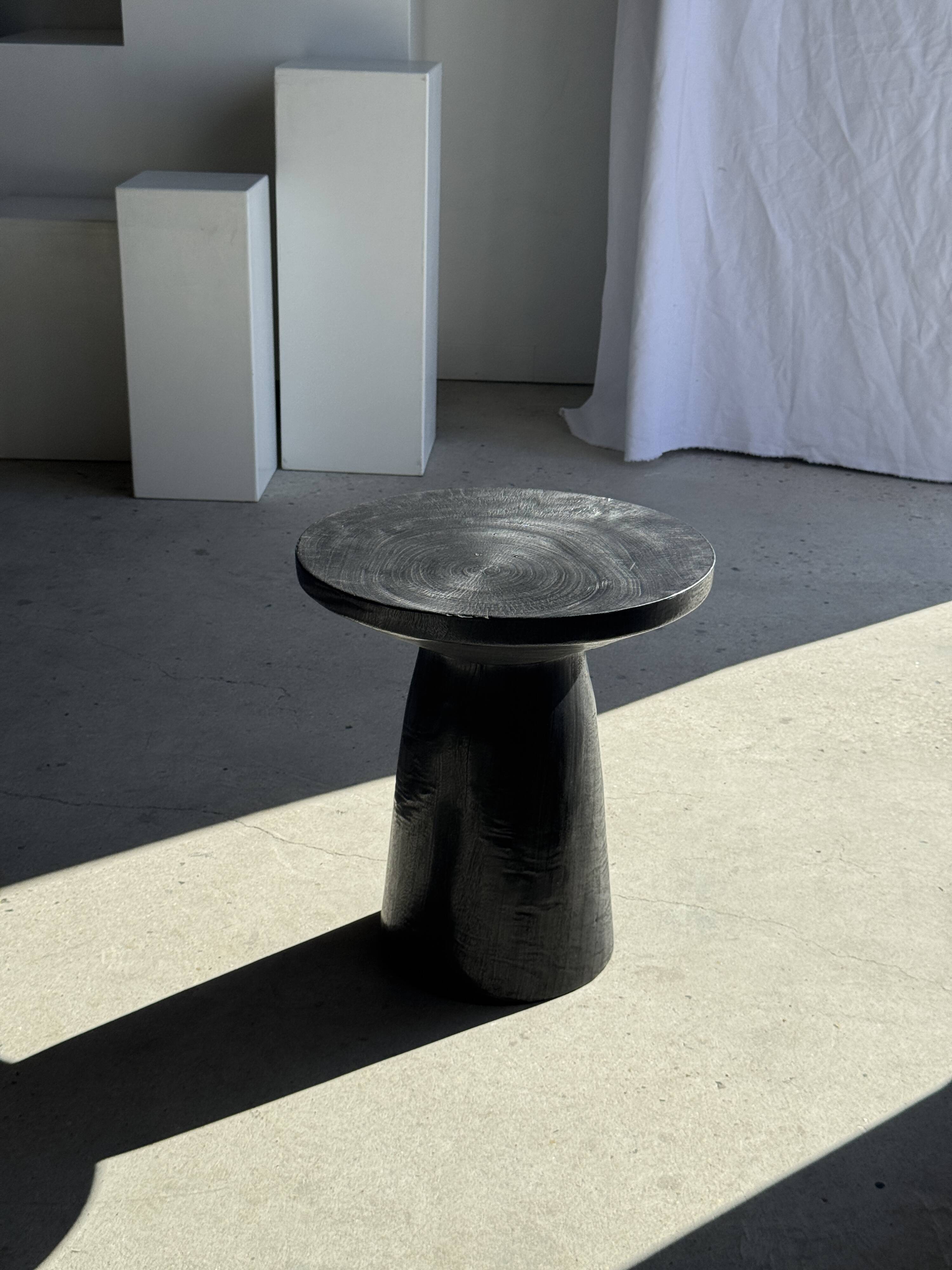 Black solid mango side table (monoxyle) with conical legs