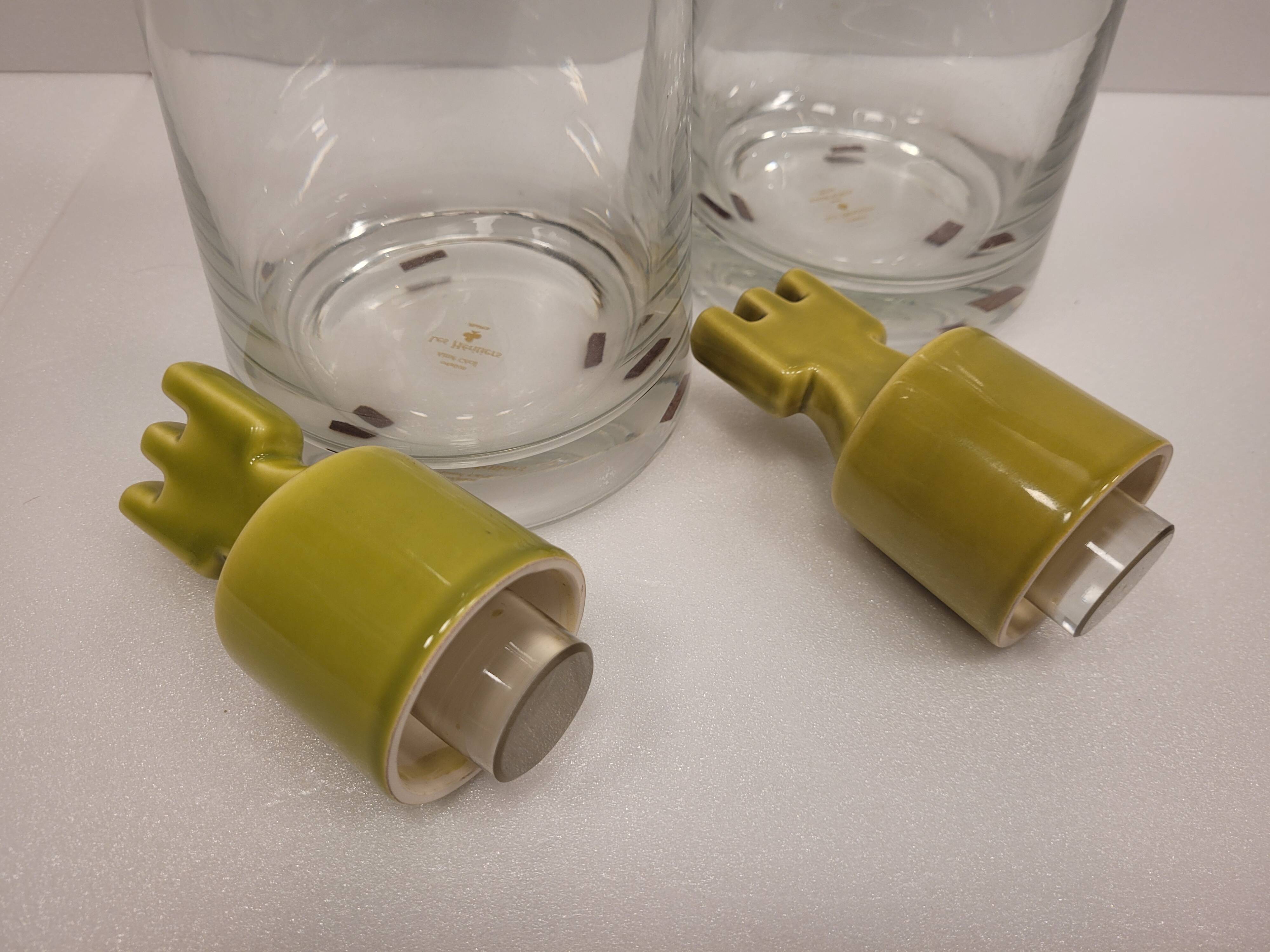 pair of decanters, bottles or jars, made in crystal with a ceramic tap enameled in green color