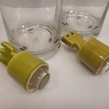 pair of decanters, bottles or jars, made in crystal with a ceramic tap enameled in green color