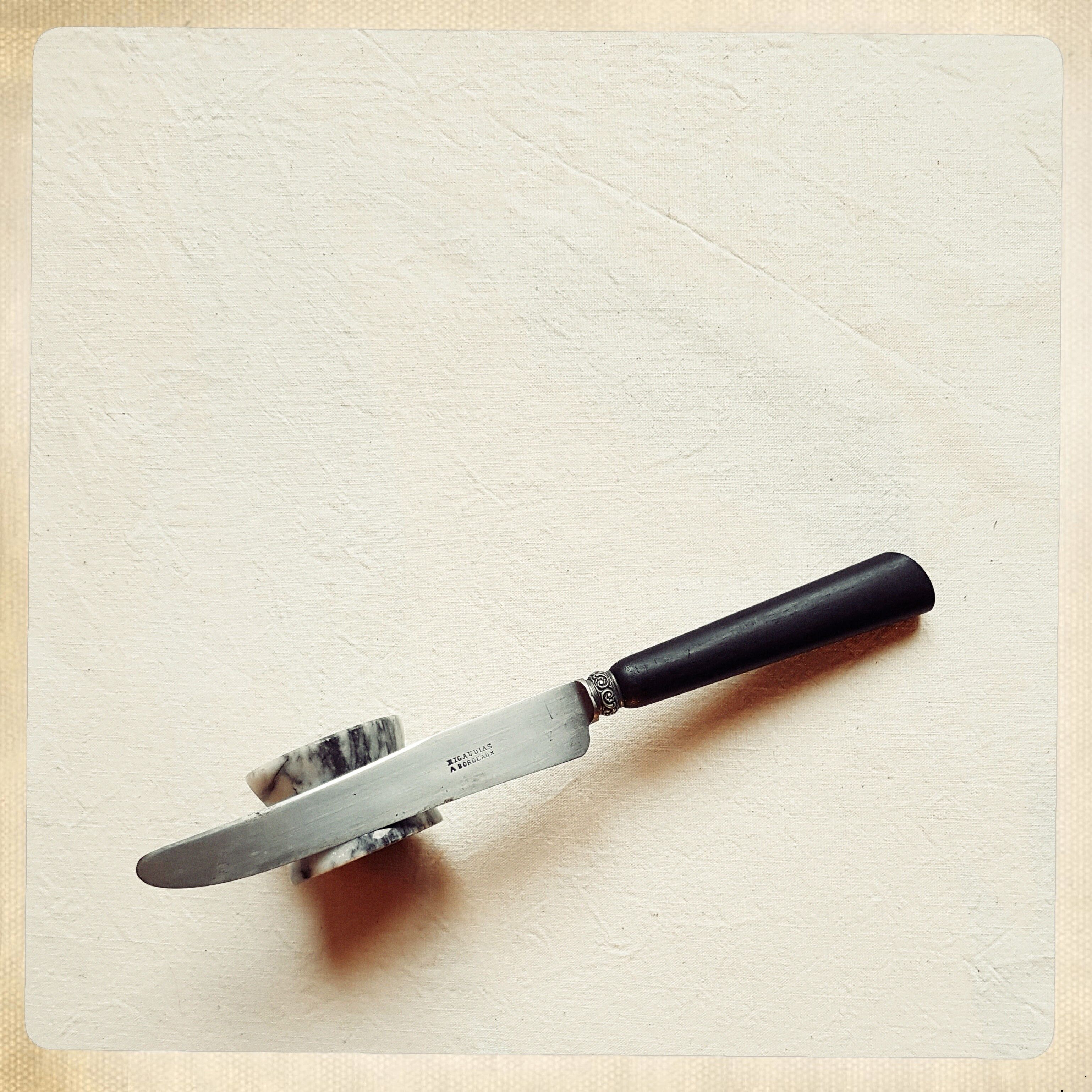 Twelve blackened wooden handle knives