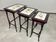 Nested tables in curved wood with ceramic top by Thonet.