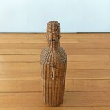 Bottle, old carafe in glass and wicker, 1950s
