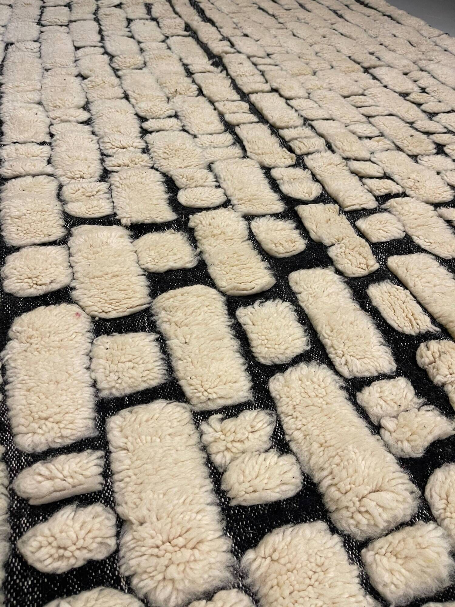 Large cream and black checked Berber rug, 280 × 200 cm.