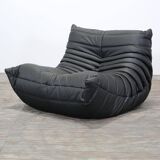 Togo armchair and footrest in black leather by Ligne Roset, designed by Michel Ducaroy.