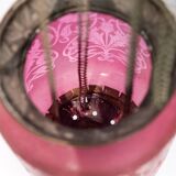 Antique pendant of pink opaline glass with brass edge and suspension from around 1860