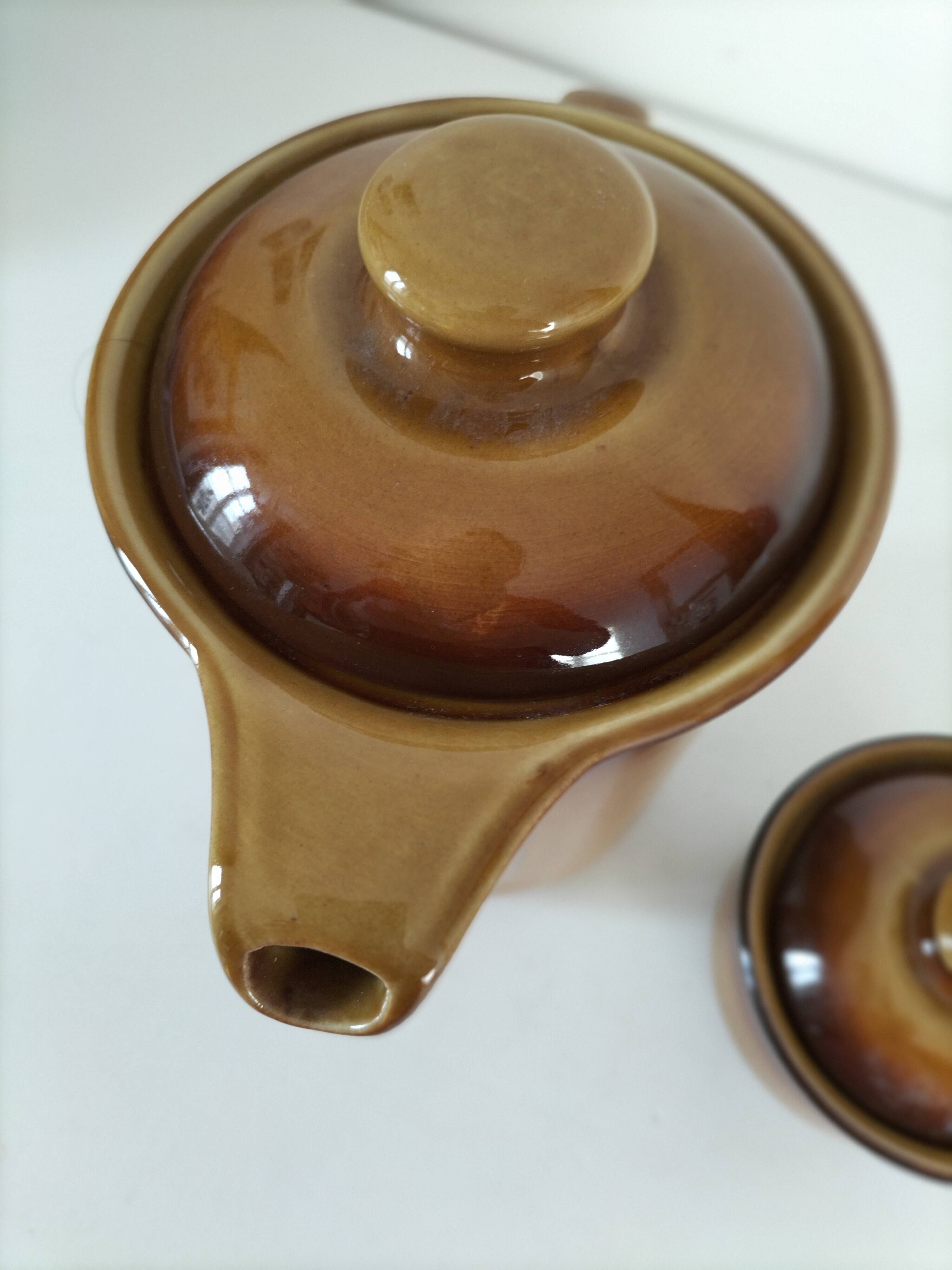 Coffee pot and sugar bowl in glazed stoneware, deep brown glazes.
