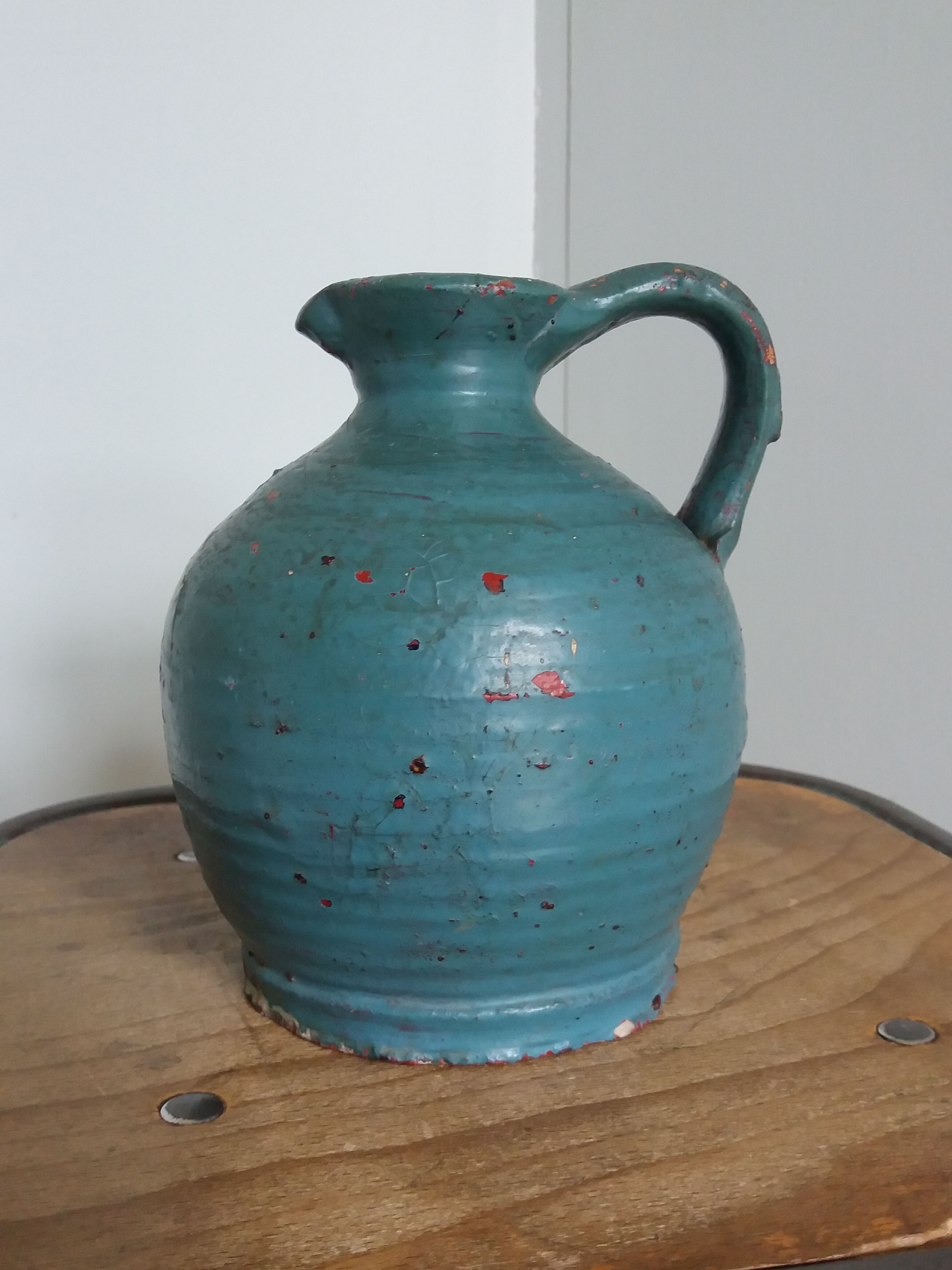 Sandstone pitcher painted in turquoise, very old pottery