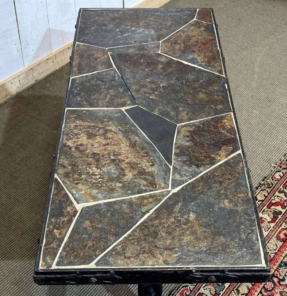 Coffee table in wrought iron with a slate top, work from the 1950s.