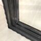 1950s mirror, matte black wood with a patina.