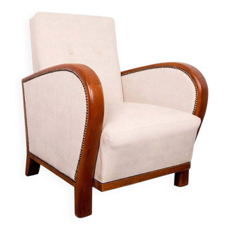 Art Deco armchair from the 1930s in beige fabric and carved wood, Hungarian origin.