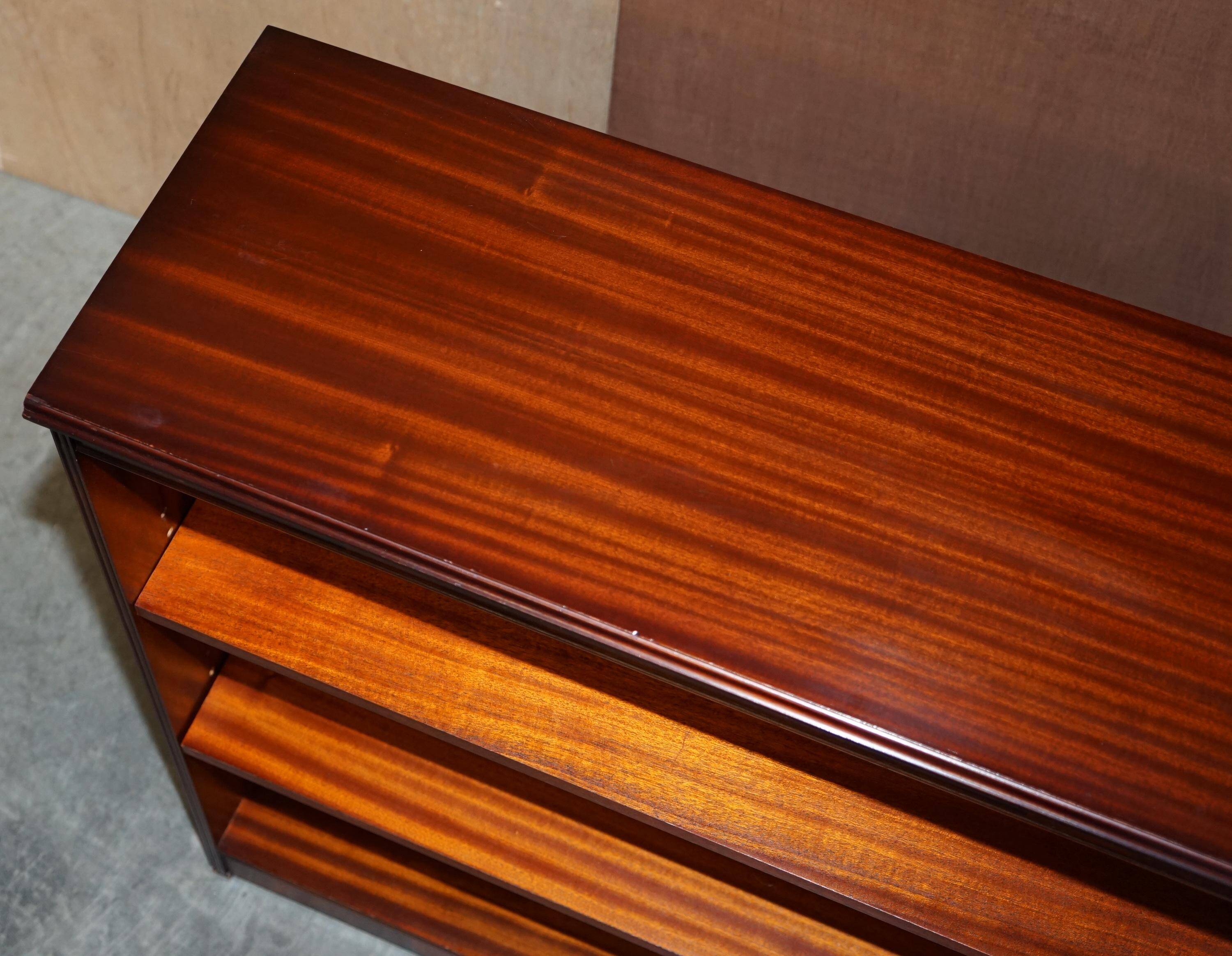 Pair of open low bookshelves Shaws of London in hardwood.