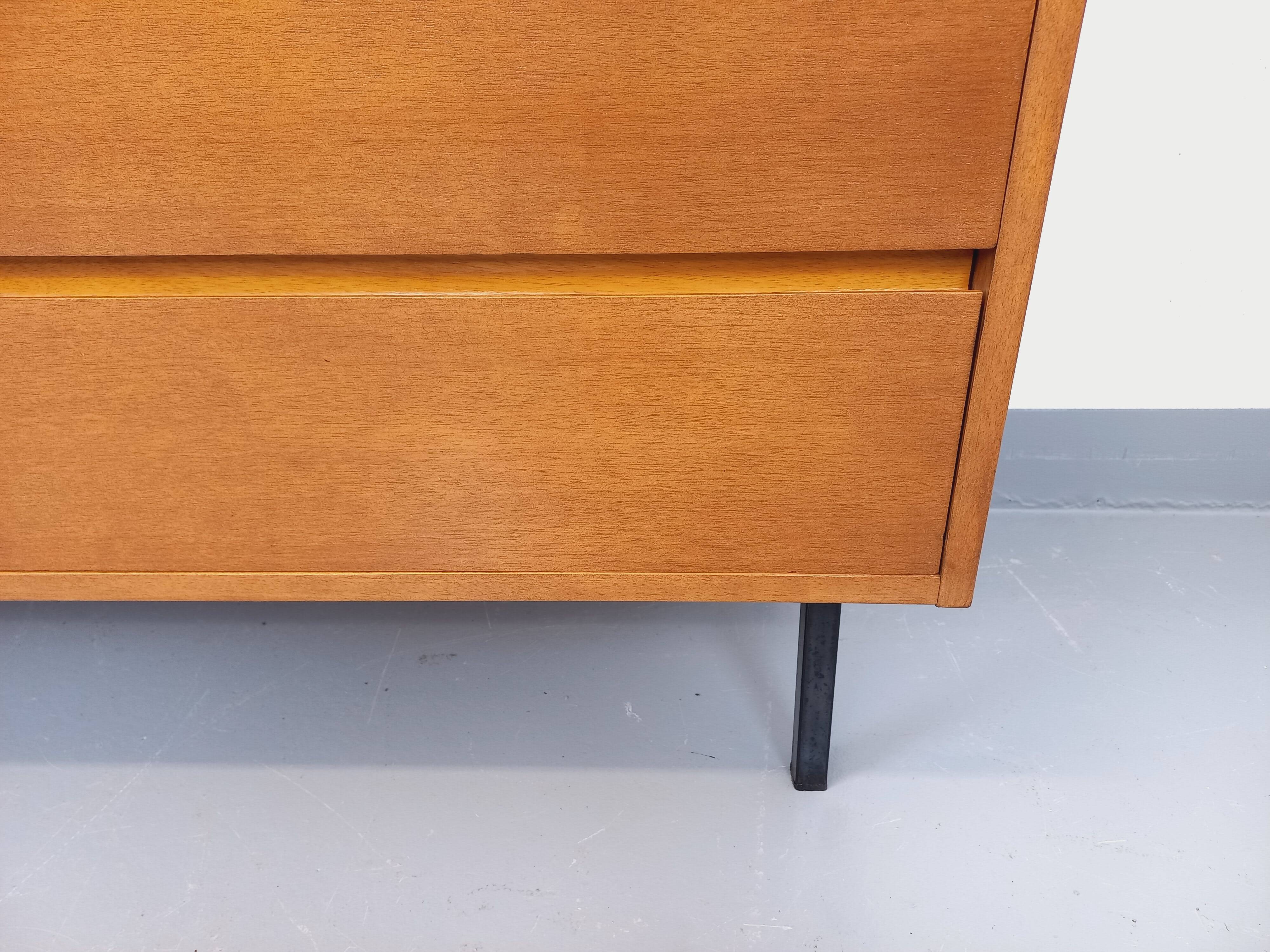 Small vintage Scandinavian sideboard in modernist style made of light oak wood.