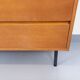 Small vintage Scandinavian sideboard in modernist style made of light oak wood.