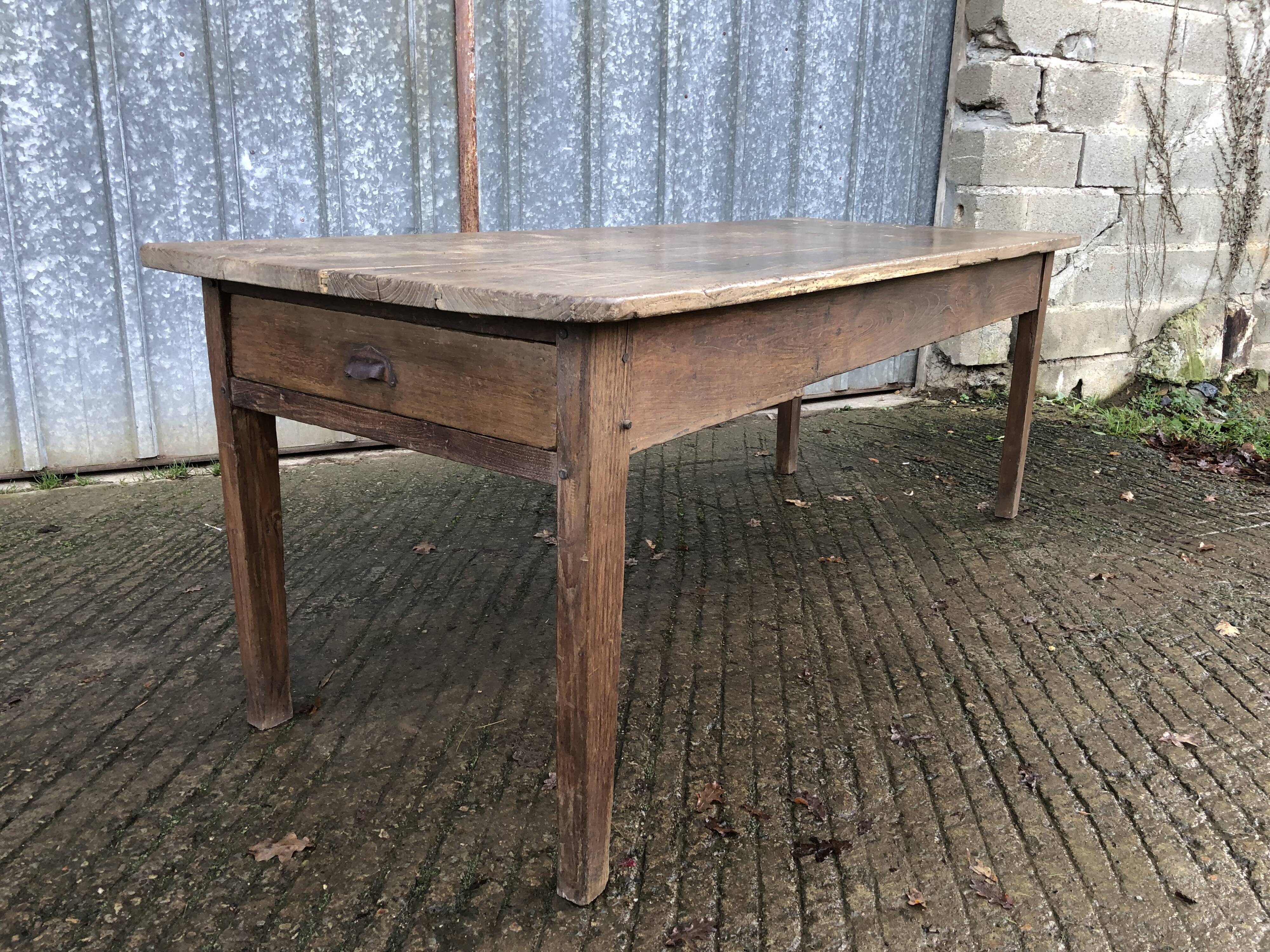 Antique farmhouse table in solid oak with tapered legs and 1 drawer at the end.