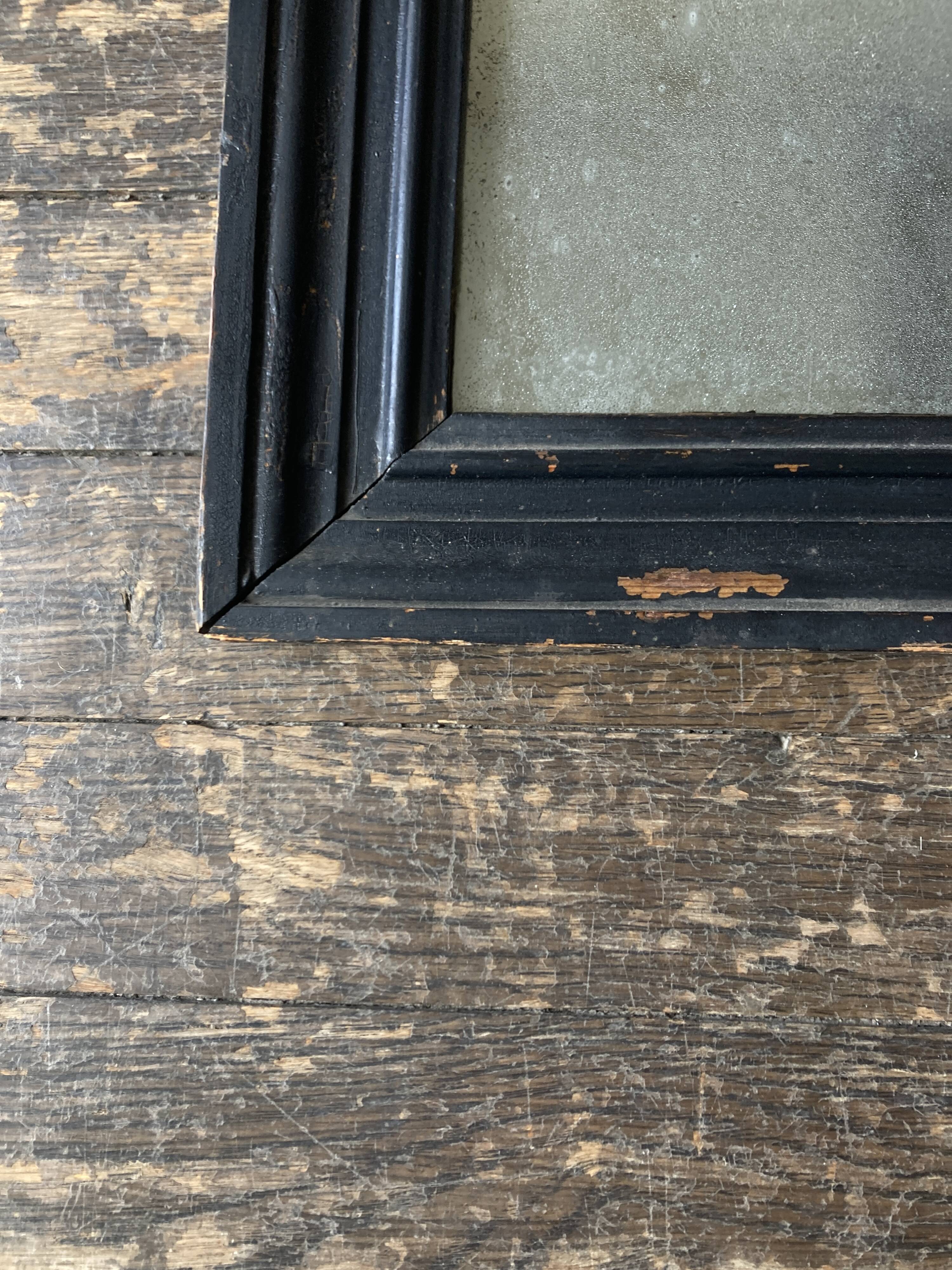 19th century blackened mirror with pitted glass 34cm x 40cm