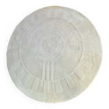 Round ecru rug with geometric relief patterns in wool