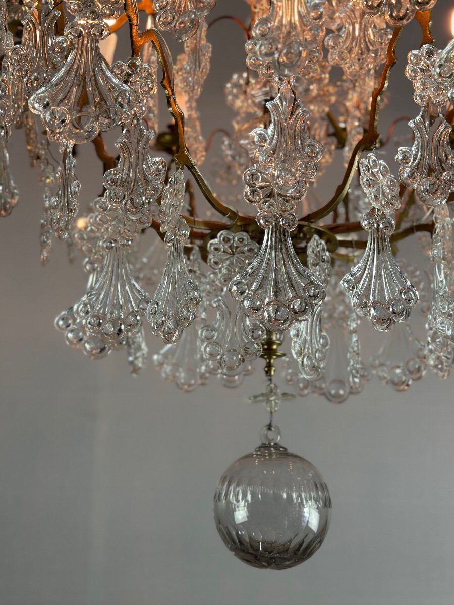 Bronze cage chandelier adorned with molded glass pendants in the shape of peacock feathers, circa 1800