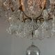 Bronze cage chandelier adorned with molded glass pendants in the shape of peacock feathers, circa 1800