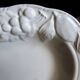 Oval white vegetable dish, an antique tableware piece in barbotine earthenware.
