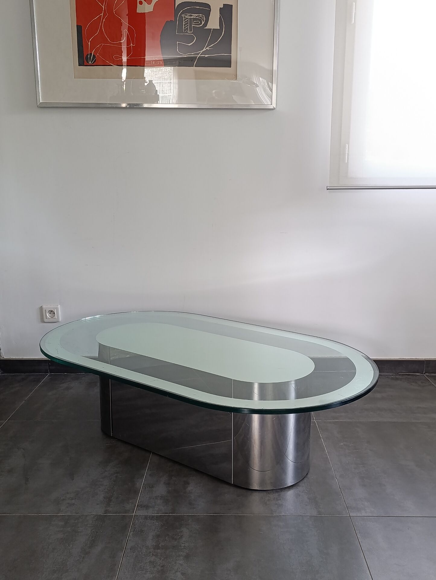 Vintage coffee table with glass and chrome metal.