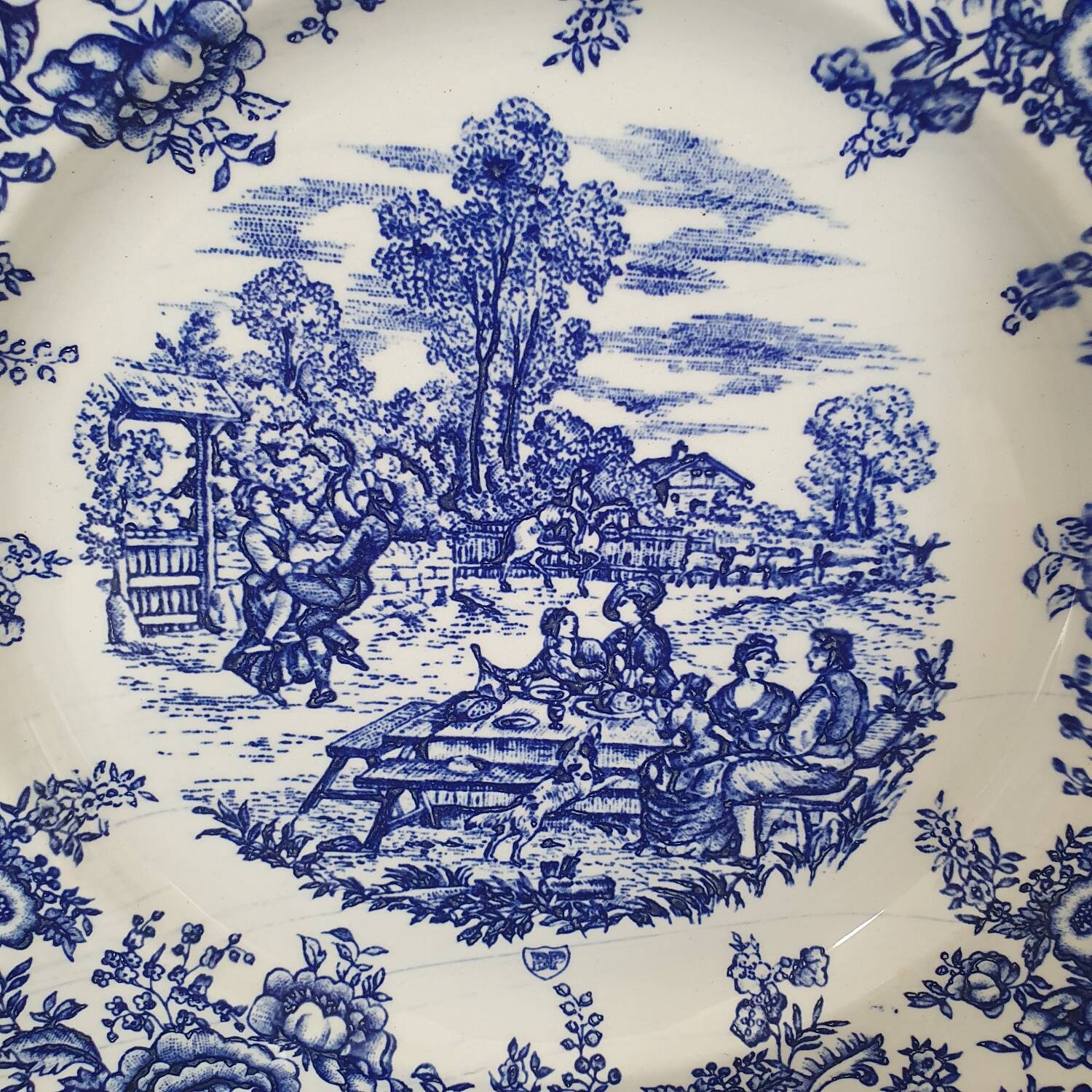 4 earthenware plates with floral and pastoral scene motif